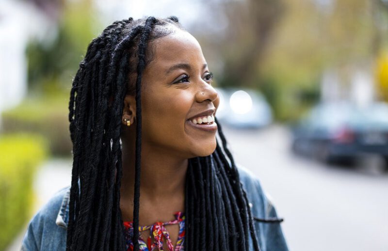 A smiling woman looking to the distance