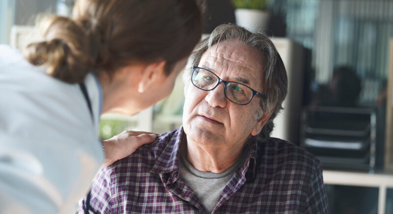 Health provider talking to a senior patient